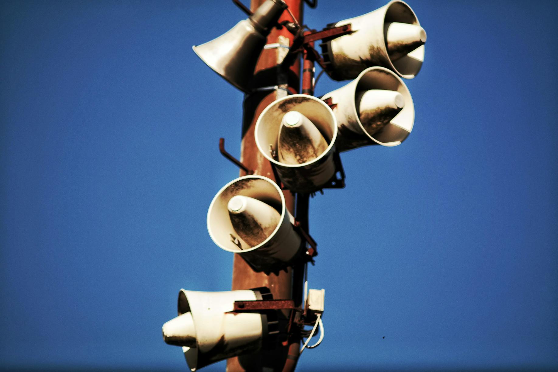 Megaphone Speakers on Wooden Post